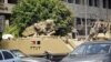Egyptian army armoured personnel carriers (APC) are stationed outside the Aguza Military Hospital in Cairo, August 19, 2013.