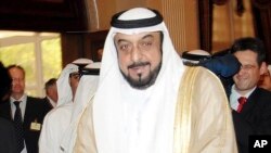 FILE - UAE President Sheikh Khalifa bin Zayed Al Nahyan walks with Germany's Chancellor Angela Merkel, unseen, in Abu Dhabi, United Arab Emirates, Feb. 5, 2007, to discuss bilateral relations. 