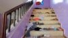 The belongings of Yemeni students are seen scattered on a staircase bearing blood stains at a school in the capital Sanaa on April 7, 2019, following explosions near the school.