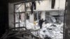 A woman walks through rubble from a building destroyed by shelling from forces loyal to Syrian President Bashar Al-Assad in downtown Aleppo August 1, 2012.