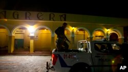 FILE - Police patrol in Liberty Square in central San Salvador, El Salvador, Aug. 20, 2018.