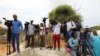 FILE - Somali journalists are seen during a stake-out on the outskirts of Mogadishu, Somalia, July 25, 2019.