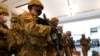 Troops stand in formation inside the visitors center to reinforce security at the Capitol in Washington, Jan. 13, 2021. 