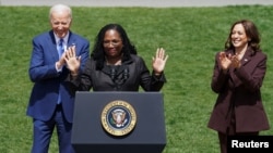 Judge Ketanji Brown Jackson acknowledges the cheers of the crowd while U.S. President Joe Biden and Vice President Kamala Harris applaud as Jackson speaks about her confirmation as the first Black woman to serve on the U.S. Supreme Court, at the White House, April 08, 2022.
