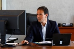 FILE - Cedric O, French junior minister for the digital sector, poses in his office in Paris.