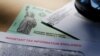 FILE - In this April 23, 2020, photo, President Donald Trump's name is seen on a stimulus check issued by the IRS to help combat the adverse economic effects of the coronavirus outbreak.