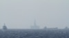 FILE - Ships and an oil rig, center, which China calls Haiyang Shiyou 981, and Vietnam refers to as Hai Duong 981, is seen in the South China Sea, off the shore of Vietnam, May 14, 2014.
