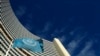 The flag of the International Atomic Energy Agency (IAEA) flies in front of its headquarters during a board of governors meeting in Vienna, Nov. 28, 2013. 