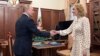 FILE - Russian President Vladimir Putin meets with Commissioner for Children's Rights Maria Lvova-Belova at the Kremlin in Moscow, March 9, 2022. The commissioner, who is being sought for war crimes for deporting children from Ukraine, said Wednesday they were taken for safety. 