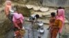 FILE - Rohingya refugees collect drinking water at the Shalbagan refugee camp in Teknaf, Bangladesh, March 5, 2019. 