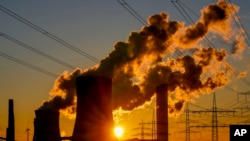FILE - Steam comes out of chimneys of a coal-fired power station in Niederaussem, Germany, Oct. 24, 2021.