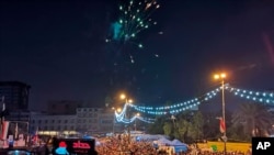 Anti-government protesters shoot fireworks in Tahrir Square, Baghdad, Nov. 29, 2019. Celebrations erupted after Iraqi Prime Minister Adel Abdul-Mahdi announced he would resign.