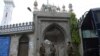 Policemen wearing facemasks stand guard outside a closed mosque during Friday prayers on a government-imposed nationwide lockdown as a preventive measure against the COVID-19 coronavirus, in Lahore on April 17, 2020.