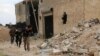 FILE - Free Syrian Army fighters run with their weapons during clashes with forces loyal to Syria's President Bashar al-Assad at the Karam Barre front line in Aleppo, Nov. 2, 2014. 