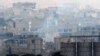 Smoke rises from central Kobani during fighting between Islamic State militants and Kurdish forces, as seen from the Turkish side of the Turkey-Syria border, Nov. 24, 2014. 