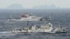 An aerial photo shows Chinese marine surveillance ships Haijian No. 49 (front) and Haijian No.50 cruising in the East China Sea, as the islands known as Senkaku isles in Japan and Diaoyu islands, April 23, 2013.