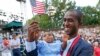Alpha Saliou Diallo, a refugee from Guinea, holds his daughter, Aisha, after he became a U.S. citizen during a special naturalization ceremony commemorating World Refugee Day at the Delacorte Theater in New York City's Central Park, June 20, 2016.