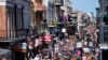 FILE - Revelers fill Bourbon Street below the balcony of the Royal Sonesta Hotel during Mardi Gras Day festivities in the French Quarter in New Orleans, Feb. 21, 2023. 
