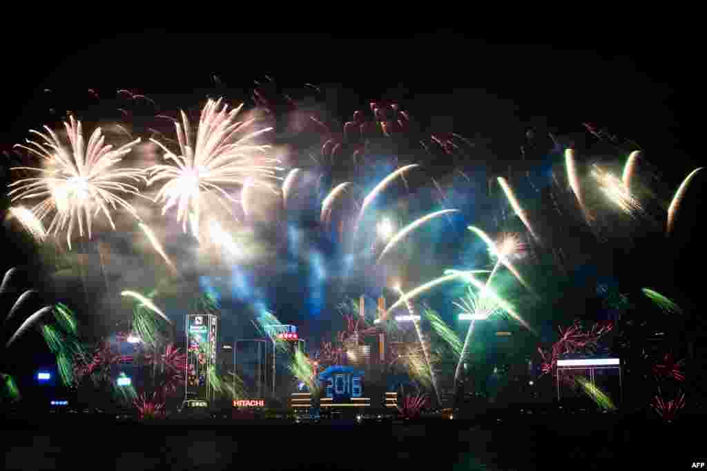 Fireworks are seen over the city&#39;s skyline in Hong Kong as part of the 2016 New Year&#39;s celebrations.