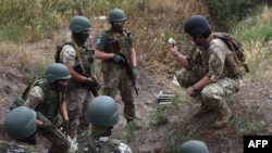 Військовослужбовці 126-ї окремої територіальної бригади Збройних Сил України беруть участь у військових навчаннях в Одеській області 22 червня 2022 року на тлі російського вторгнення в Україну. (Фото Олександр ГІМАНОВ / AFP)