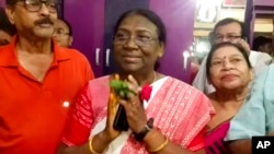 FILE - India's governing Bharatiya Janata Party's presidential candidate Draupadi Murmu greets well-wishers who called on her at Raigangpur in Odisha, India, June 22, 2022. 