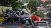 FILE - Ugandan riot police patrol on the streets of the Kamwokya neighborhood.