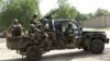 FILE - Niger soldiers provide security for an anti-Boko Haram summit in Diffa city, Niger, Sept. 3, 2015.