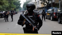 FILE - An armed police officer stands guard following a blast at a district police station, that according to authorities was a suspected suicide bombing, in Bandung, West Java province, Indonesia, Dec. 7, 2022. 