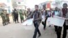 Members of the election commission remove election material after hearing news of a possible attack on polling booths by protesters in Bogra, Jan. 5, 2014. 