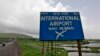 A signboard is pictured at the proposed site of Navi Mumbai airport, about 45 km (27 miles) east of Mumbai, August 8, 2012. 