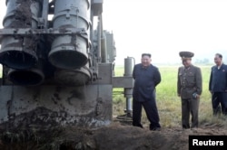 FILE - North Korean leader Kim Jong Un attends the testing of a super-large multiple rocket launcher in North Korea, in this undated photo released Sept. 10, 2019 by North Korea's Korean Central News Agency.