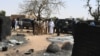 Mali's President Ibrahim Boubacar Keita inspects the damage after an attack by gunmen on Fulani herders in Ogossagou, Mali, March 25, 2019.