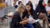 Samira Chaouachi (R) with colleagues at a recent Heart of Tunisia party meeting in Tunis. (L. Bryant/VOA)