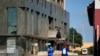 Men wearing protective masks walk down a deserted street on the first day of the 21-day nationwide lockdown aimed at limiting the spread of coronavirus disease (COVID-19) in Harare, Zimbabwe, March 30, 2020.