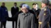 India's Prime Minister Manmohan Singh (front) takes part in a welcoming ceremony next to an honour guard upon his arrival at Moscow's Vnukovo airport, Oct. 20, 2013.