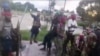 FILE - Image taken from militant video released by the Islamic State group on March 29, 2021, purporting to show fighters near the strategic north eastern Mozambique town of Palma.