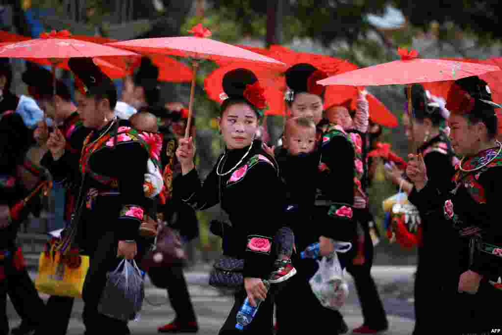 Women of the Miao ethnic minority in traditional costumes parade to celebrate the Miao new year festival in Leishan county, in China&#39;s southwestern Guizhou province, Nov. 18, 2020.