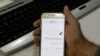 FILE - A man holds a smartphone connected to a Wifi network without internet access, at an office in the Iranian capital Tehran, Nov. 17, 2019.