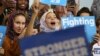 FILE - Young Muslim women listen to Democratic candidate Hillary Clinton speak at a voter registration rally in Detroit, Michigan, Oct. 10, 2016. Out of some 3.3 million Muslims living in America, about 1.5 million are eligible to vote, data shows.