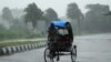 Rickshaw driver plows through heavy rain in Berhampur, about 180 kilometres south of Bhubaneswar, Oct. 12, 2013.