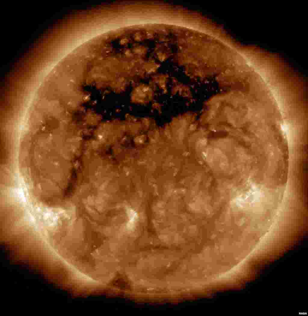 The dark area across the top of the sun in this image NASA's Solar Dynamics Observatory is a coronal hole, a region on the sun where the magnetic field is open to interplanetary space, sending coronal material speeding out in what is called a "high-speed solar wind stream."