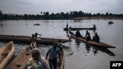 FILE - Central African refugees arrive in Ndu after crossing the Mbomou River, which marks the border between the Central African Republic and the Democratic Republic of Congo, Feb. 5, 2021. 