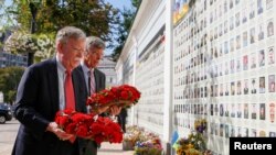 U.S. National Security Adviser John Bolton and U.S. Embassy Charge d'Affairs William Taylor attend a wreath-laying ceremony at the memorial for soldiers killed in a recent conflict in eastern Ukraine, in Kyiv, Ukraine, Aug. 27, 2019.