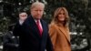 FILE - U.S. President Donald Trump walks with first lady Melania Trump while departing for Palm Beach, Fla., from the White House in Washington, Feb. 1, 2019.