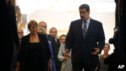 U.N. High Commissioner for Human Rights Michelle Bachelet, left, chats with Venezuela's President Nicolas Maduro, as they walk out of a meeting at Miraflores Presidential Palace, in Caracas, Venezuela, Friday, June 21, 2019. The United Nations' top…