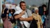 Palestinians flee north Gaza towards the south, amid the ongoing conflict between Israel and Palestinian Islamist group Hamas, in the central Gaza Strip