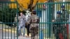 A French soldier arrives with flowers at the 5th Combat Helicopter Regiment (5th RHC) base in Uzein near Pau, France, Nov. 26, 2019. Thirteen French soldiers were killed in Mali when their helicopters collided at low altitude.