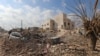 FILE - Destruction is seen around the Udai hospital following airstrikes on the town of Saraqeb in Syria's northwestern province of Idlib, Jan. 29, 2018. 