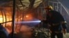 A firefighter inspects a fire inside a garment factory in Gazipur, Bangladesh, Oct. 9, 2013.