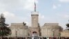 People walk outside the presidential palace before Afghanistan's President Ashraf Ghani's oath, during his inauguration as president in Kabul, March 9, 2020.